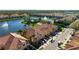 Aerial view showcasing a residential area with a lake, pool, and townhomes featuring beautiful terracotta roofs at 3456 Parkridge Cir # 33-105, Sarasota, FL 34243