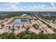 Scenic aerial view of a condominium complex with a central lake, lush landscaping, and convenient parking at 3456 Parkridge Cir # 33-105, Sarasota, FL 34243