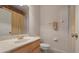 Bathroom featuring a marble countertop vanity, toilet, and shower with beige tile at 3456 Parkridge Cir # 33-105, Sarasota, FL 34243