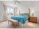 Cozy bedroom featuring a decorative bed, side tables, and a window with a view at 3456 Parkridge Cir # 33-105, Sarasota, FL 34243