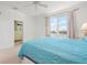Bedroom with large window overlooking lake and custom closet at 3456 Parkridge Cir # 33-105, Sarasota, FL 34243