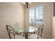 Cozy breakfast nook with a beautiful view to the lake, and decorative wallpaper at 3456 Parkridge Cir # 33-105, Sarasota, FL 34243
