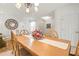 Bright dining area with a wooden table set, complemented by neutral walls and a decorative mirror at 3456 Parkridge Cir # 33-105, Sarasota, FL 34243