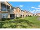 Exterior view of the homes featuring manicured lawns and screened patios at 3456 Parkridge Cir # 33-105, Sarasota, FL 34243
