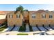 A row of townhomes with garages and tile roofs, fronted by palm trees, landscaped lawns, and paved driveways at 3456 Parkridge Cir # 33-105, Sarasota, FL 34243