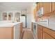 Well-equipped kitchen with white countertops, wood cabinets and modern appliances at 3456 Parkridge Cir # 33-105, Sarasota, FL 34243