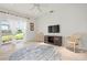 Serene living room with ample natural light, a cozy rug, and sliding glass doors overlooking a serene view at 3456 Parkridge Cir # 33-105, Sarasota, FL 34243