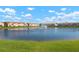 Community homes surrounding a scenic pond with a fountain in the center at 3456 Parkridge Cir # 33-105, Sarasota, FL 34243