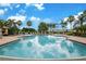 Inviting community pool with ample deck space, lush landscaping, and adjacent residential buildings at 3456 Parkridge Cir # 33-105, Sarasota, FL 34243