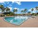 Sparkling community pool with ample deck space, palm trees, and clearly marked depths for swimmers at 3456 Parkridge Cir # 33-105, Sarasota, FL 34243