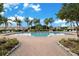 Inviting community pool with paved deck, tropical landscaping, and ample seating for residents at 3456 Parkridge Cir # 33-105, Sarasota, FL 34243