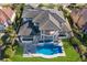 Aerial view showcasing the home, pool, landscaping, and waterfront location in a well manicured neighborhood at 348 W Royal Flamingo Dr, Sarasota, FL 34236