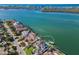 Stunning aerial view of a waterfront home highlighting its private dock, pool and proximity to the bay at 348 W Royal Flamingo Dr, Sarasota, FL 34236