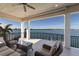 Spacious covered balcony with seating area offering panoramic water views at 348 W Royal Flamingo Dr, Sarasota, FL 34236