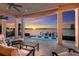 Inviting outdoor patio space with comfortable seating and sunset water views with a pool below at 348 W Royal Flamingo Dr, Sarasota, FL 34236