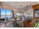 Open-concept dining and living area with a chandelier, water views and bright natural light at 348 W Royal Flamingo Dr, Sarasota, FL 34236