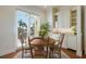 Dining room with a round wood table, seating for four, and lots of natural light at 348 W Royal Flamingo Dr, Sarasota, FL 34236