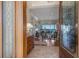 Elegant foyer showcases a glimpse into a luxurious living room, with water views, a fireplace and beautiful furnishings at 348 W Royal Flamingo Dr, Sarasota, FL 34236