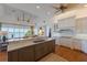 Open concept kitchen featuring stainless steel appliances, an island, hardwood floors, and water views at 348 W Royal Flamingo Dr, Sarasota, FL 34236