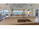 Open concept kitchen featuring stainless steel appliances, an island, hardwood floors, and water views at 348 W Royal Flamingo Dr, Sarasota, FL 34236