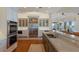 Spacious kitchen featuring stainless steel appliances, marble countertops, tile backsplash, and hardwood floors at 348 W Royal Flamingo Dr, Sarasota, FL 34236