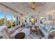 Inviting living room with panoramic water views, custom built-ins, and comfortable seating at 348 W Royal Flamingo Dr, Sarasota, FL 34236