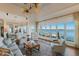 Elegant living room boasting water views, fan, comfortable seating, and lots of natural light at 348 W Royal Flamingo Dr, Sarasota, FL 34236