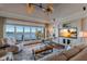 Bright and spacious living room with water views, a ceiling fan, and a comfortable seating arrangement at 348 W Royal Flamingo Dr, Sarasota, FL 34236
