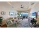 Bright living room boasts a coffered ceiling, water view, and sliding doors to the outdoor deck at 348 W Royal Flamingo Dr, Sarasota, FL 34236