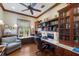 Cozy office space with hardwood floors, custom cabinetry, and built-in shelving at 348 W Royal Flamingo Dr, Sarasota, FL 34236