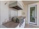 The outdoor kitchen area features a built in grill, backsplash, and access to the home at 348 W Royal Flamingo Dr, Sarasota, FL 34236