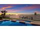 Inviting waterfront pool with dock and stunning sunset views of the city skyline at 348 W Royal Flamingo Dr, Sarasota, FL 34236