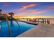 Inviting waterfront pool with dock and stunning sunset views of the city skyline at 348 W Royal Flamingo Dr, Sarasota, FL 34236