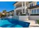 Exterior of a home featuring a pool with tile accents, covered patio, and balcony at 348 W Royal Flamingo Dr, Sarasota, FL 34236