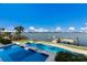 Beautiful view of the pool, dock, and bay on a sunny day with clear blue skies at 348 W Royal Flamingo Dr, Sarasota, FL 34236