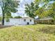 Spacious backyard with green grass, white fence, and partially shaded area at 3512 N 10Th St, Tampa, FL 33605