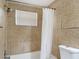 Tiled bathroom with a shower/tub combination and a window at 3512 N 10Th St, Tampa, FL 33605