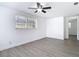 Bright bedroom featuring a ceiling fan and modern gray vinyl floors at 3512 N 10Th St, Tampa, FL 33605