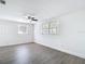 Bright bedroom featuring a ceiling fan and modern gray vinyl floors at 3512 N 10Th St, Tampa, FL 33605