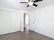Bright bedroom with a ceiling fan, closet with sliding doors, and sleek flooring at 3512 N 10Th St, Tampa, FL 33605