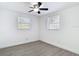 Bright bedroom featuring a ceiling fan and modern gray vinyl floors at 3512 N 10Th St, Tampa, FL 33605