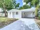 Charming home featuring a carport, a fresh driveway, and colorful landscaping at 3512 N 10Th St, Tampa, FL 33605