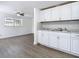 Bright kitchen featuring bright cabinets, dual sink, and modern gray vinyl floors at 3512 N 10Th St, Tampa, FL 33605