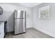 Bright kitchen featuring stainless steel refrigerator, white cabinets, and modern flooring at 3512 N 10Th St, Tampa, FL 33605