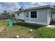 Relaxing backyard view with chairs and trampoline on a grassy lawn at 3525 Emory Dr, Holiday, FL 34691