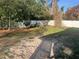 Spacious backyard with lush greenery and a white fence, offering privacy and outdoor space at 3525 Emory Dr, Holiday, FL 34691