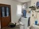 Practical laundry room featuring a washer, storage shelves, and a door to the exterior at 3525 Emory Dr, Holiday, FL 34691