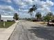 Picturesque neighborhood street with palm trees and well-kept homes under a sunny sky at 3525 Emory Dr, Holiday, FL 34691