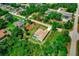 Aerial view of single-story home with pool nestled among mature trees, reflecting privacy in a residential area at 3528 Monday Ter, North Port, FL 34286