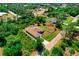 Aerial view of single-story home with long driveway, attached two-car garage, side lot, and screened pool at 3528 Monday Ter, North Port, FL 34286